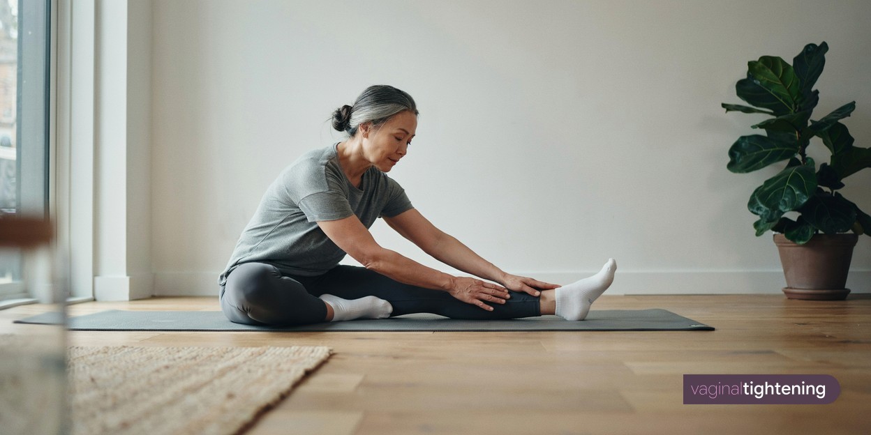 A woman stretching on an exercise mat at home